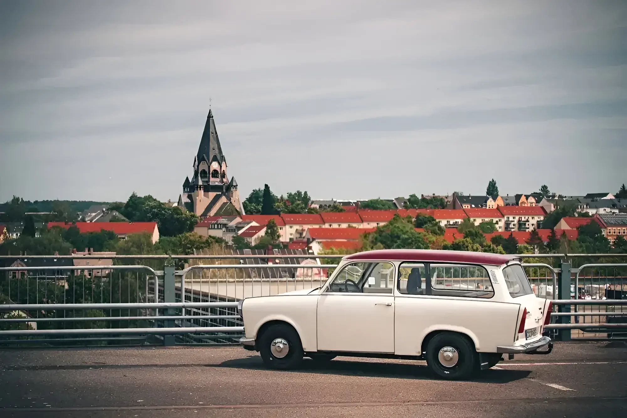 Trabant 601 Universal 1989 mieten in Trabant Vermietung Chemnitz, Rosenpl. 7, 09126 Chemnitz-Bernsdorf, Deutschland (Seitenansicht mit Kirchturm)